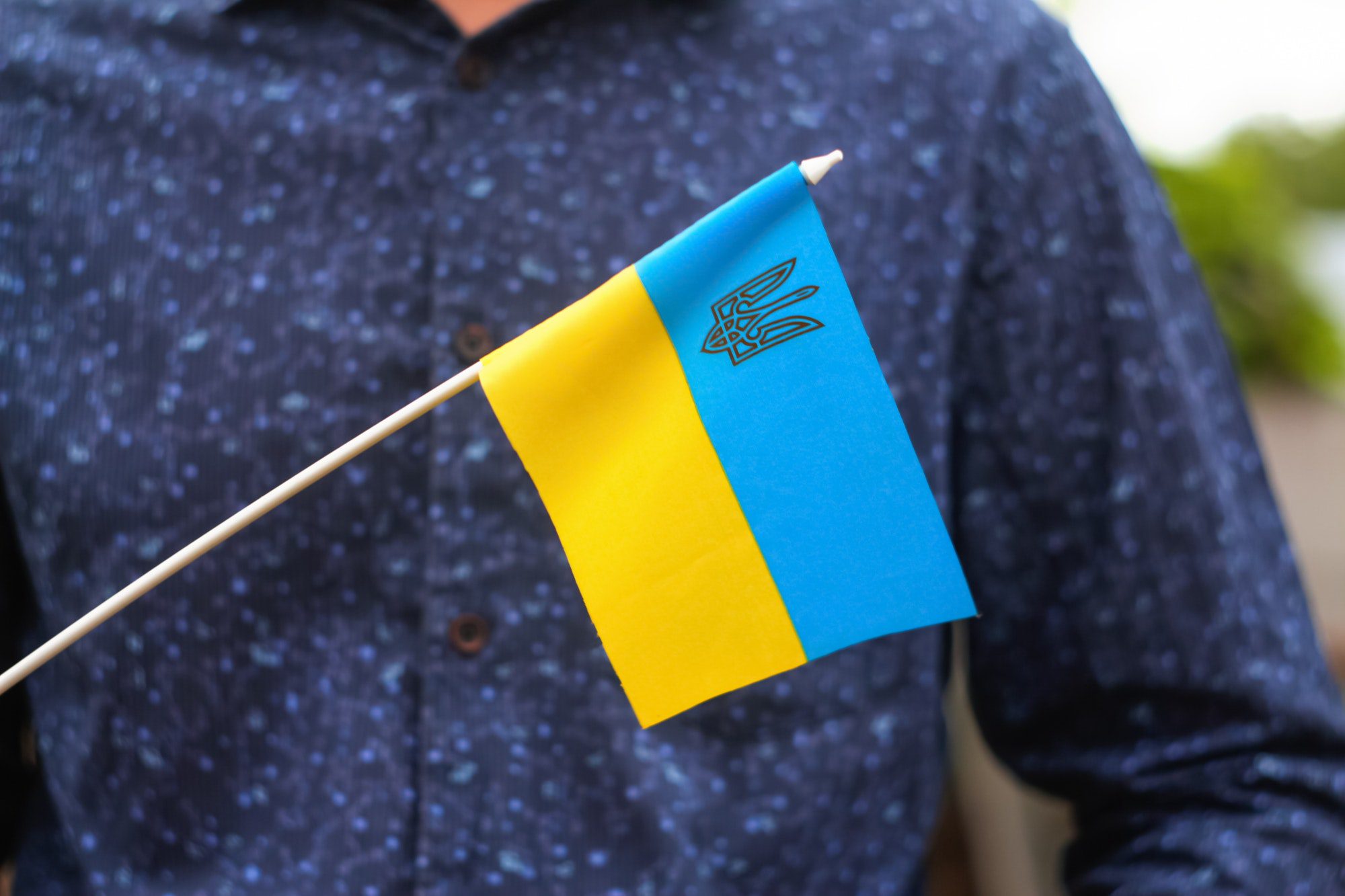 Photography of flag of Ukraine. Close up waving flag of Ukraine and emblem. Flag symbol of Ukraine.