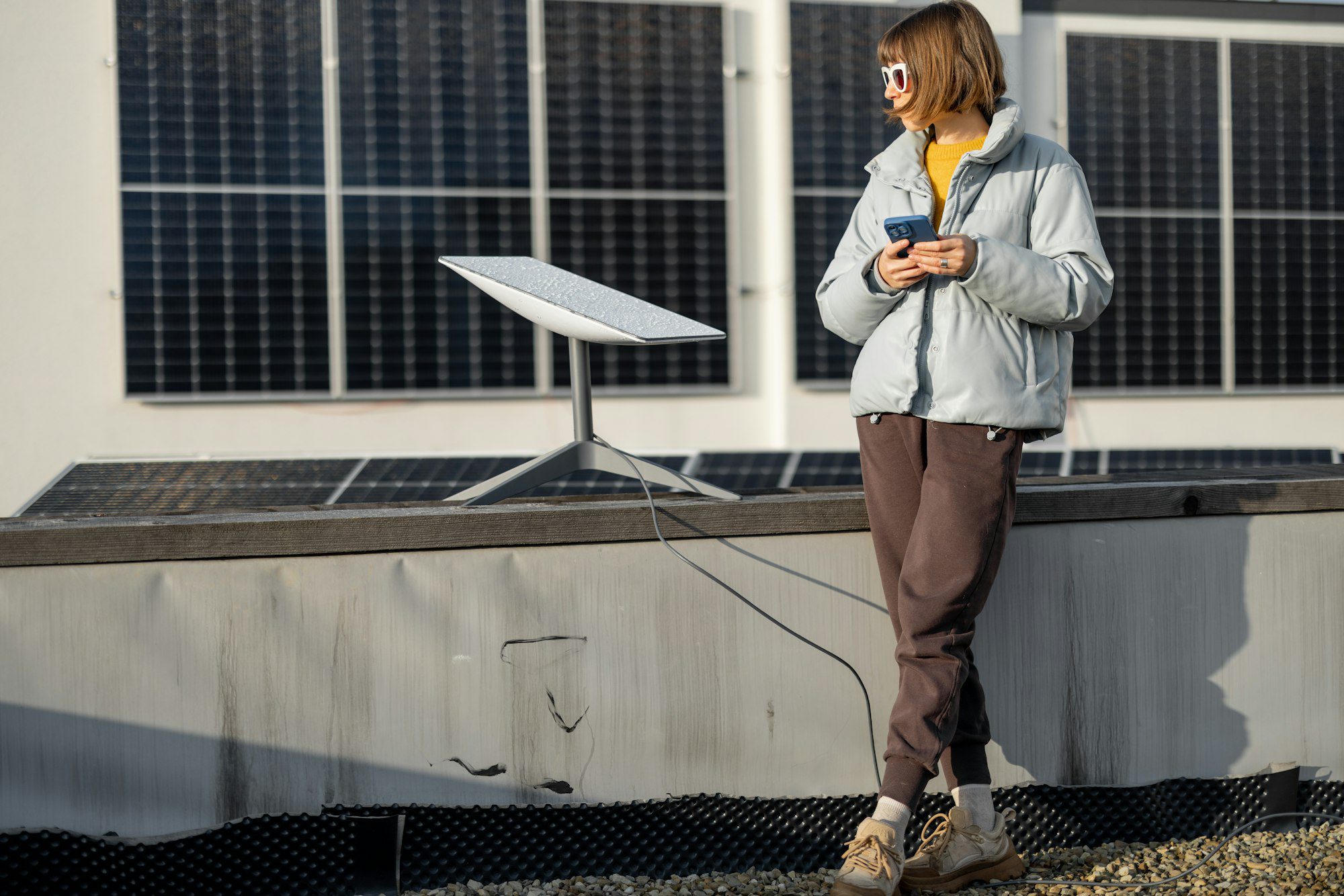 Woman uses Starlink Internet on roof with solar panels