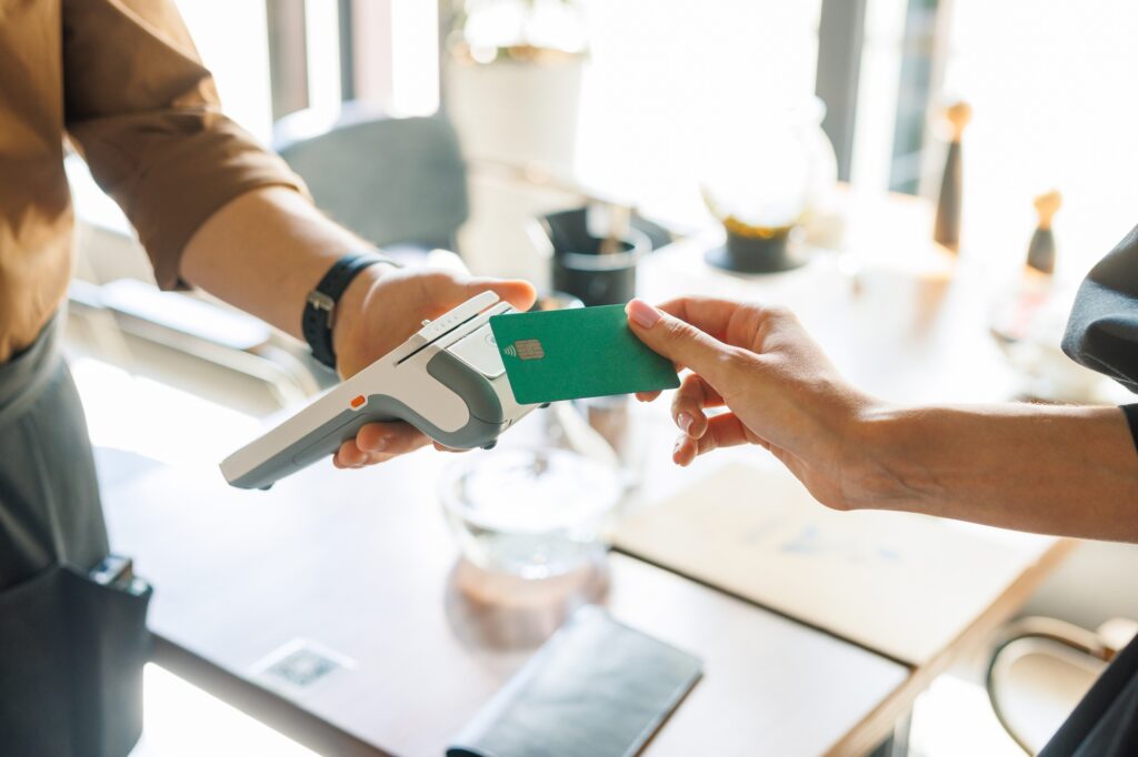 NFC credit card payment. Woman paying with contactless credit card with NFC
